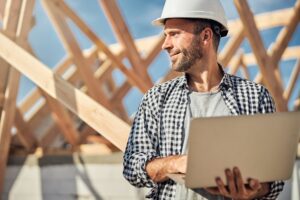 Busy field engineer controlling the process of house construction